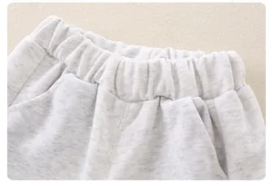 Close-up of comfortable elastic waistband and pockets on grey cotton baby trousers