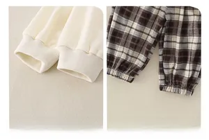 Detail view of elastic ribbed cuffs and plaid pant texture for soft baby clothing set