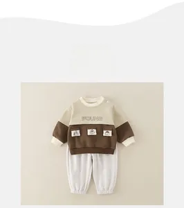 Detail view of cotton infant set featuring color-block sweatshirt and gray knit pants