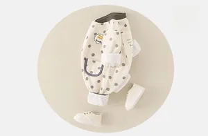 Detail of baby romper featuring grey polka dots and a cute giraffe cartoon badge