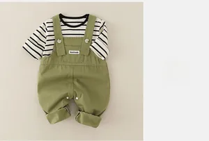 Detail of baby cotton striped shirt and green overalls set with handmade label