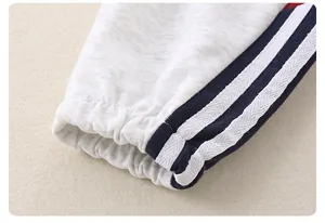 Detailed macro view of elastic ribbed cuffs with sporty blue and white side stripes