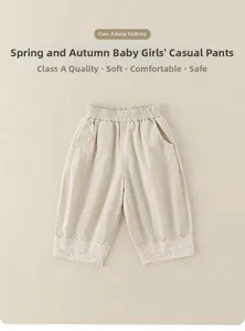 Detail of infant girl cotton casual pants with elastic waist and delicate lace trim edge