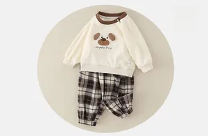 Detail of baby sweatshirt with 3D dog patch and plaid trousers in soft cotton