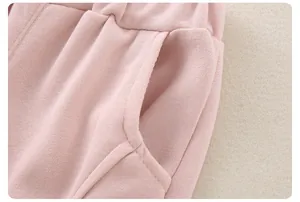 Detail of pink toddler cotton pants showing elastic waist, side pocket and soft fabric texture