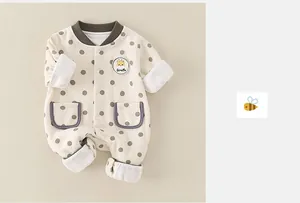 Detailed view of baby romper featuring polka dots and giraffe patch embroidery