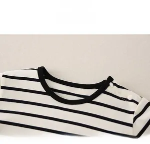 Close-up of the cotton striped baby top featuring a round neck and shoulder buttons
