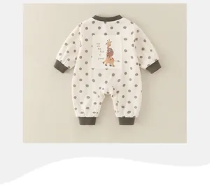 Close-up of baby bodysuit back featuring giraffe cartoon patch and polka dot pattern
