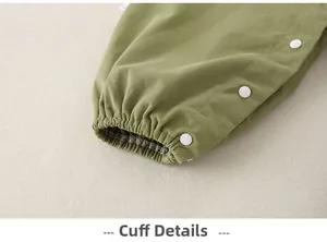 Detailed close-up of elastic leg opening with white snap buttons on baby cotton trousers