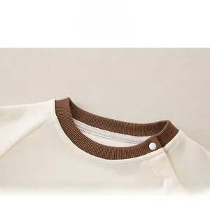 Close-up of baby ribbed sweatshirt with round neck and side snap buttons for easy dressing