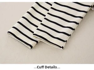 Macro shot of striped cotton infant outfit cuff details with high-quality stitching