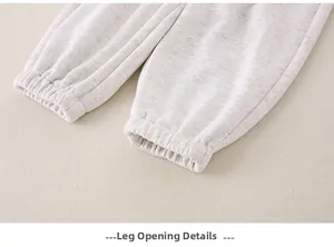 Detail view of elastic cuffs on light gray cotton jogger pants for baby boys