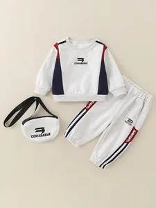 Toddler three-piece cotton tracksuit featuring grey sweatshirt, pants, and small crossbody bag