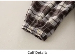 Detailed close-up of elastic leg cuffs on infant plaid trousers with quality stitching