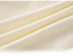 Close-up of baby ribbed knit fabric in cream white, soft and elastic textile texture