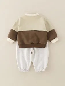 Baby boy two-piece cotton set with beige sweatshirt and grey joggers for spring