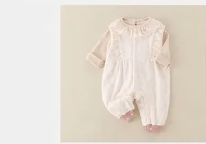 Detail of baby romper featuring delicate lace ruffle collar and soft ribbed cuffs