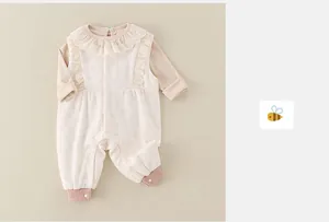 Detailed view of baby romper featuring delicate lace collar and soft ribbed cuffs