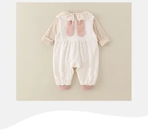 Detail of baby romper featuring a lace collar and cute 3D bunny ears on the back