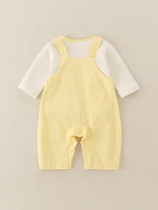 Infant girl cotton two-piece set with long sleeve top and yellow overalls in flat lay view