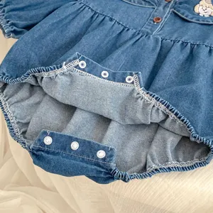 Detail of snap button crotch and cute cartoon dog embroidery on denim baby romper