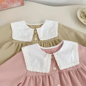 Detail of baby girls' Peter Pan lace collars and button-up shirts in khaki and pink