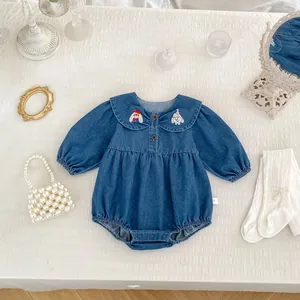 Detailed view of baby denim romper with Peter Pan collar and cartoon embroidery