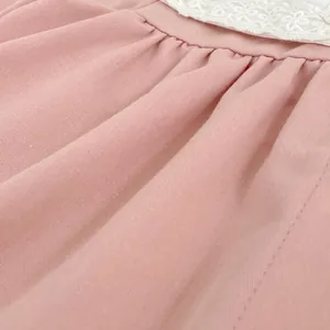 Pink girl's cotton dress with delicate white lace trim and pleated texture details