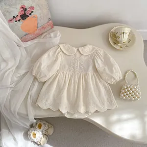 Dettaglio body neonata con ricami floreali, colletto Peter Pan e maniche a palloncino