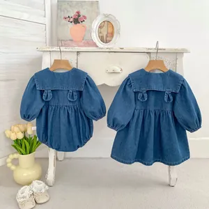 Close-up of denim dress with bunny ear back pockets and sailor collar for girls