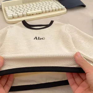 Toddler boys long sleeve cream shirt with Abc embroidery and ribbed elastic fabric