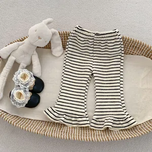 Detail of girls striped knit flare pants with ruffle hem and soft waffle texture