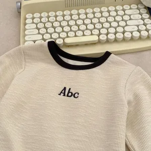 Toddler boys long-sleeve waffle knit shirt with Abc embroidery and black crew neck collar