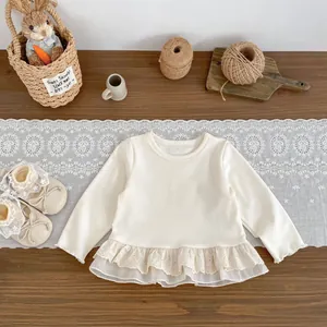 Creamy white long sleeve baby top with layered lace hem and matching toddler shoes