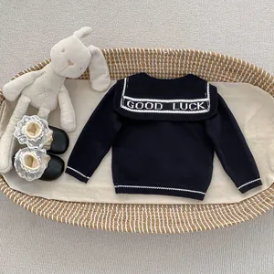Detail of navy knit cardigan with Good Luck collar and white stripes for girls