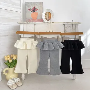 Dettaglio della vita a balze e del fondo a campana sui pantaloni in maglia per bambine