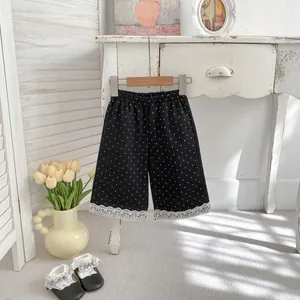 Pantaloni a gamba larga per bambine neri a pois con pizzo e vita elastica per primavera