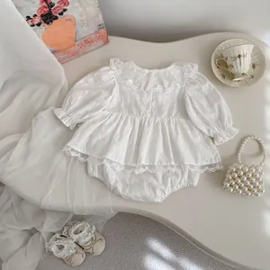 Detailed view of white floral lace collar and puffed sleeves on baby bodysuit