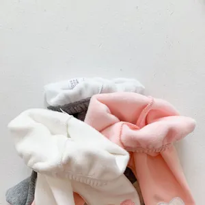 Close-up of thick fleece lining on multi-colored winter leggings for babies