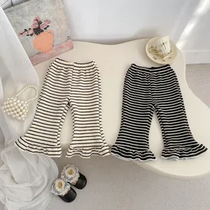 Detail view of girls striped flare pants with elastic high waist and ruffle hem