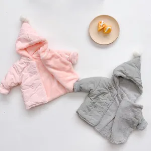 Detail view of baby hooded jacket with fleece lining and cute pompom decorations