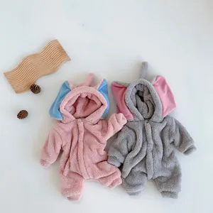 Detail of plush baby elephant onesie featuring soft flannel texture and cute 3D ear hood