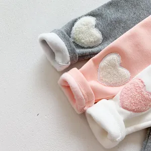 Close-up of warm fleece lining and cute heart patches on winter baby leggings