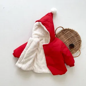 Detail of red baby winter coat with warm fleece lining and decorative pom-pom on hood