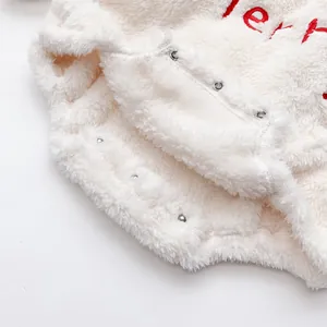 Close-up of baby white plush romper with metal crotch snaps and soft fleece texture
