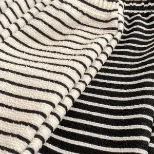 Close-up of girls' knit sweater set showing waffle texture and black white stripes