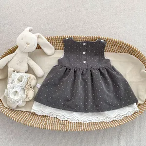 Detalle de vestido de lunares para niña con borde de encaje bordado y peluche conejo