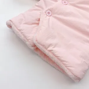 Macro shot of pink quilted baby coat with warm fleece lining and matching button detail