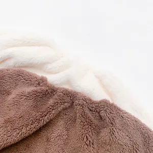 Close-up of soft fluffy cream and brown fleece fabric texture for baby Christmas romper