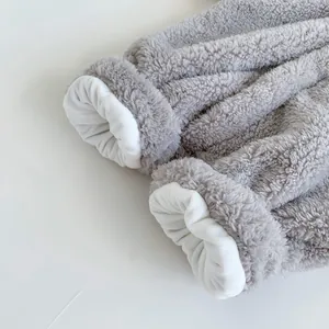 Detail of baby elephant romper cuffs with warm coral fleece and soft white lining